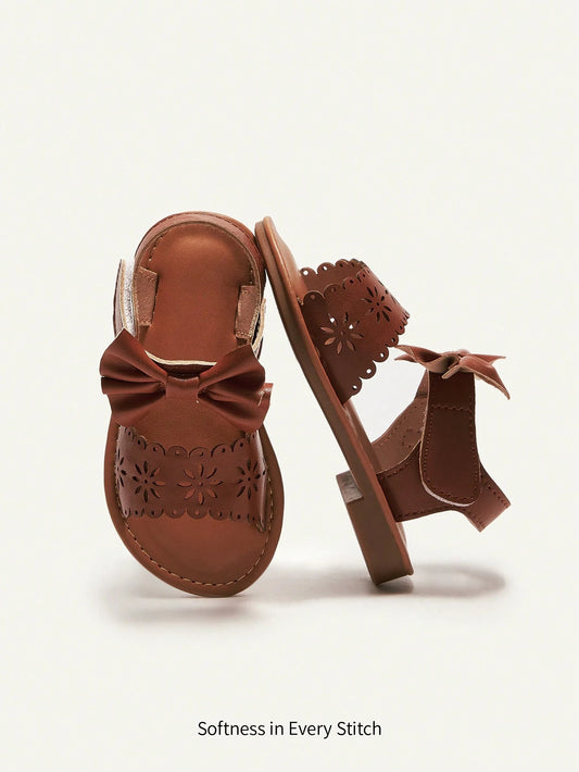 Cozy Pixies Fashionable And Cute Princess Style Baby Flat Sandals With Laser Cut Bow Decor Brown
