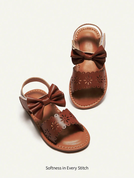 Cozy Pixies Fashionable And Cute Princess Style Baby Flat Sandals With Laser Cut Bow Decor