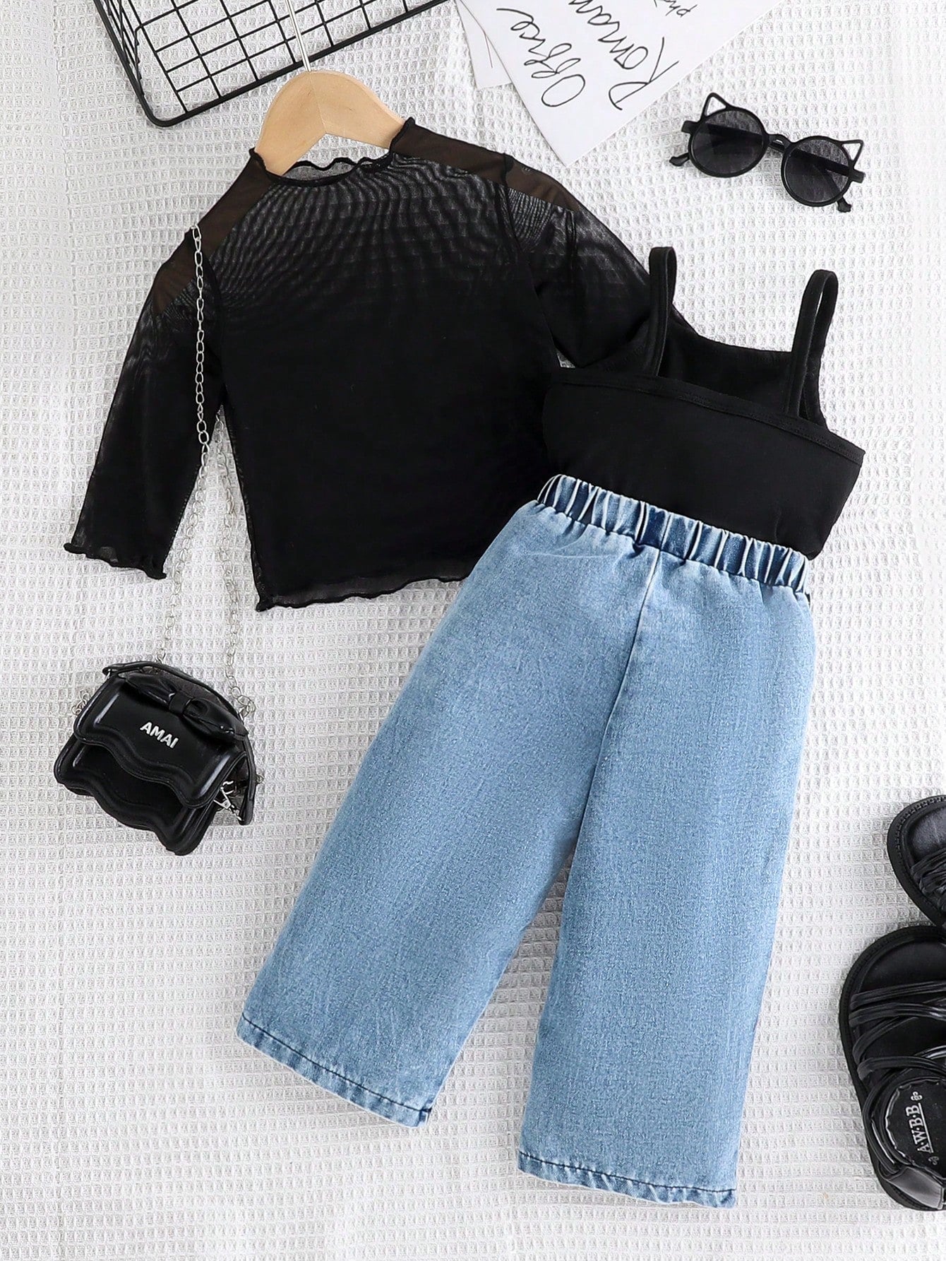 Black Mesh Top, Matching Camisole, And Blue Denim Pants